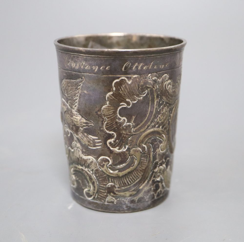 An 18th century Russian embossed white metal beaker, dated 1776, with later inscription, 75mm, 71.9 grams.
